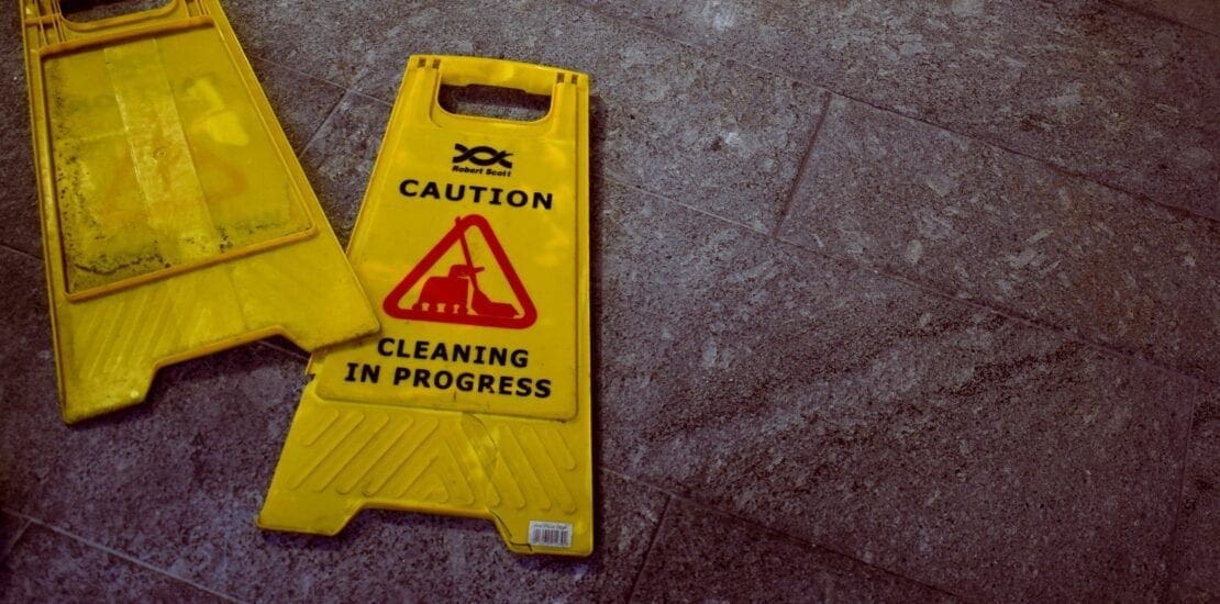 Two wet floor signs on the ground